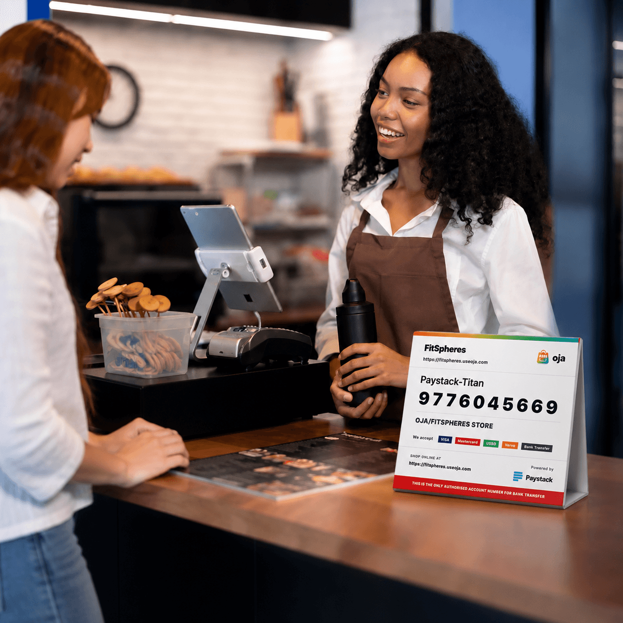 Merchant checkout counter with Oja Terminal payment sign and POS